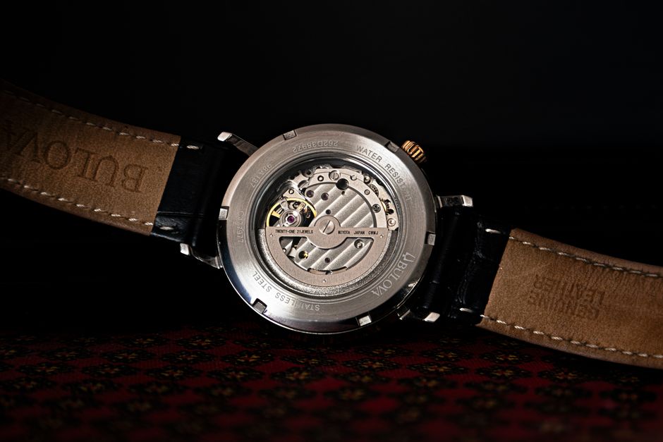 Close-up of the intricate mechanics on the back of a luxury watch.